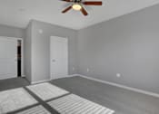 Thumbnail 37 of 37 - a bedroom with grey walls and a ceiling fan | Centerpointe Apartments in Camp Hill