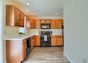 Thumbnail 53 of 58 - A kitchen with wooden cabinets and appliances.