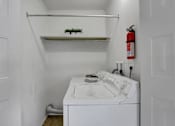 Thumbnail 23 of 26 - Apartments in Williamsport | Woodland Park |a small laundry room with a white washer and dryer