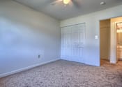 Thumbnail 7 of 10 - A room with a carpeted floor and a ceiling fan.