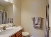 Thumbnail 48 of 58 - A bathroom with a toilet, sink, and towel rack.