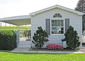 Thumbnail 3 of 3 - A house with a grey siding and a white roof.