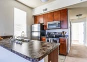 Thumbnail 6 of 18 - a kitchen with stainless steel appliances and granite counter tops
