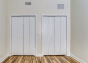 Thumbnail 11 of 18 - an empty room with two closets and wooden floors
