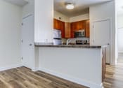 Thumbnail 2 of 18 - an empty kitchen with a counter top and a microwave