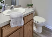 Thumbnail 34 of 51 - Mechanicsburg Apartments | Rockledge Townhomes |half bathroom with a toilet sink and mirror