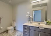 Thumbnail 10 of 20 - Mount Joy Senior Housing | a bathroom with a toilet sink and mirror