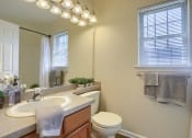 Thumbnail 45 of 51 - Mechanicsburg Apartments | Rockledge Townhomes |  a bathroom with a toilet sink and mirror