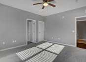 Thumbnail 34 of 37 - a bedroom with gray walls and a ceiling fan | Centerpointe Apartments in Camp Hill