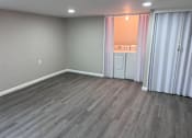 Thumbnail 10 of 23 - A room with a grey floor and white walls.