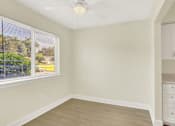 Thumbnail 9 of 39 - A room with a window and a ceiling fan.