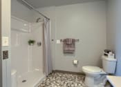 Thumbnail 11 of 20 - Mount Joy Senior Housing | a bathroom with a shower toilet and sink