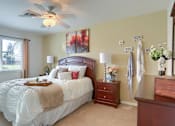 Thumbnail 24 of 39 - Harrisburg Apartment | Twin Lakes Apartments | a bedroom with a large bed and a dresser