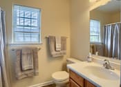 Thumbnail 58 of 58 - A bathroom with a toilet, sink, and towel rack.