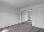 Thumbnail 21 of 26 - Apartments in Williamsport | Woodland Park |a bedroom with white walls and carpet