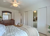 Thumbnail 25 of 39 - Harrisburg Apartment | Twin Lakes Apartments | a bedroom with white walls and a ceiling fan