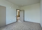 Thumbnail 13 of 20 - Mount Joy Senior Housing | a bedroom with a carpeted floor and a door that leads to a hallway