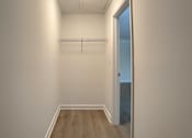 Thumbnail 15 of 39 - A room with a door and a coat rack.