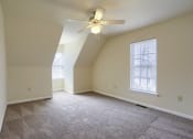 Thumbnail 38 of 51 - Mechanicsburg Apartments | Rockledge Townhomes |an empty bedroom with a ceiling fan and two windows