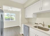 Thumbnail 2 of 39 - A kitchen with a refrigerator, dishwasher, and a sink.