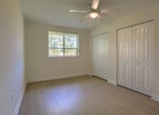 Thumbnail 13 of 39 - A room with a ceiling fan and a window.