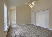 Thumbnail 56 of 58 - A room with a ceiling fan and carpeted floor.