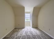 Thumbnail 46 of 58 - A room with a carpeted floor and a window.