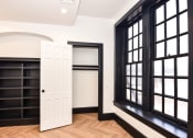 Thumbnail 2 of 26 - a room with black windows and a white door and a book shelf