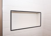 Thumbnail 16 of 26 - a white tiled bathroom with a mirror in the shower