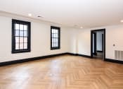 Thumbnail 8 of 26 - the living room and hallway of a new home with wood flooring and windows