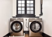 Thumbnail 15 of 26 - a washer and dryer in a laundry room with a window
