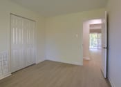 Thumbnail 31 of 39 - A room with a white door and wooden floor.