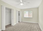 Thumbnail 7 of 39 - A room with a ceiling fan and a window.