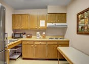 Thumbnail 8 of 15 - McConellsburg Elderly Housing | a kitchen with a refrigerator freezer and a stove top oven