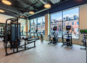 Thumbnail 18 of 67 - A gym with a view of the city outside the window.