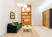 Thumbnail 14 of 67 - A living room with a green couch and a coffee table.