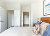 Thumbnail 8 of 67 - A bedroom with a large bed and a painting on the wall.