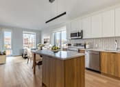 Thumbnail 43 of 67 - A modern kitchen with wooden cabinets and a large island.