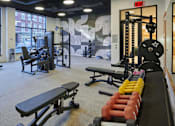 Thumbnail 38 of 67 - a fitness room with weights and cardio equipment and a large window
