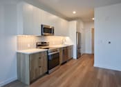 Thumbnail 35 of 67 - a kitchen with stainless steel appliances and white cabinets