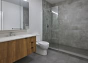 Thumbnail 32 of 67 - a bathroom with a toilet and a sink and a shower