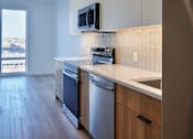 Thumbnail 41 of 67 - a kitchen with white cabinets and stainless steel appliances