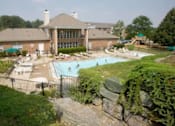 Thumbnail 4 of 20 - A large house with a pool in the backyard.