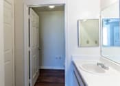 Thumbnail 11 of 20 - A white bathroom with a sink and mirror.
