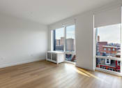 Thumbnail 28 of 67 - A room with a window overlooking a cityscape.