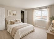 Thumbnail 44 of 48 - A bedroom with a large bed and a window with curtains.