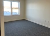 Thumbnail 15 of 19 - A room with a window and a carpeted floor.