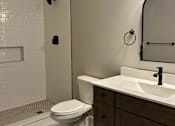 Thumbnail 3 of 15 - a bathroom with a toilet and a sink and a shower
