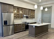 Thumbnail 14 of 15 - a kitchen with stainless steel appliances and wooden cabinets