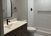 Thumbnail 11 of 15 - a bathroom with a sink and a toilet and a shower